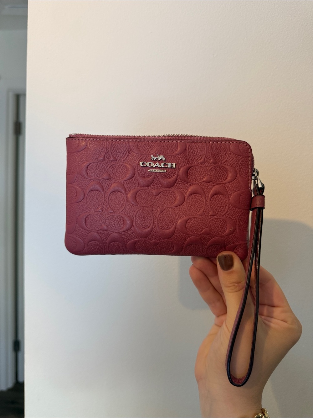 COACH Embossed Signature Wristlet in Berry